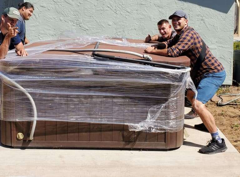 Wrapped Hottub with movers standing next to it